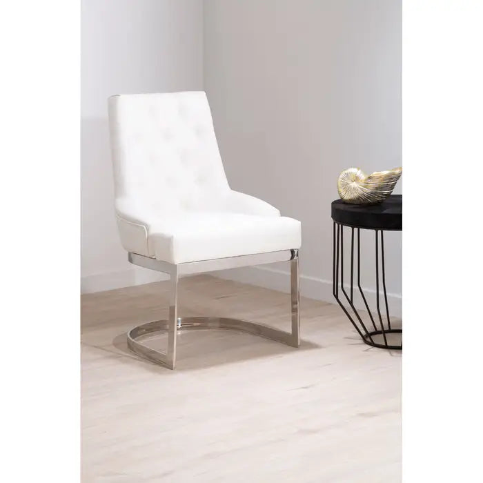 Dining chair pictured front on with black side table with ornament.