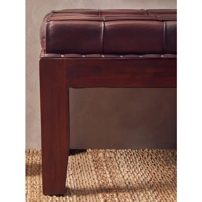 Antique brown leather, this bench has a soft button tufted seat.