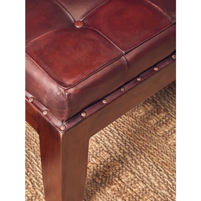 Antique brown leather, this bench has a soft button tufted seat.