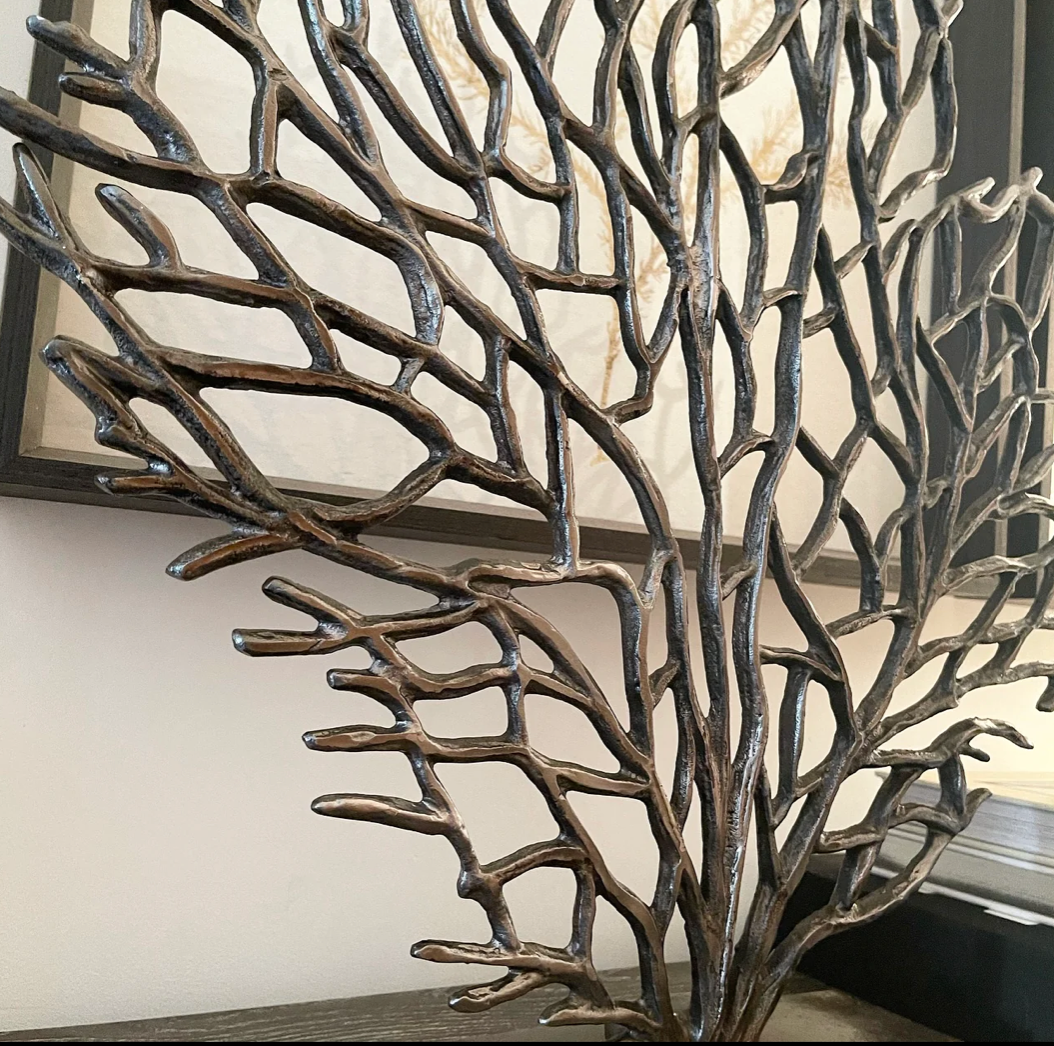 Close up ornament stands on a slim rectangular stand, and the sculpture spreads its branches upwards and outwards.