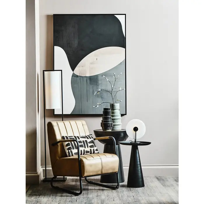  Grey leather armchair with sleek black iron frame.