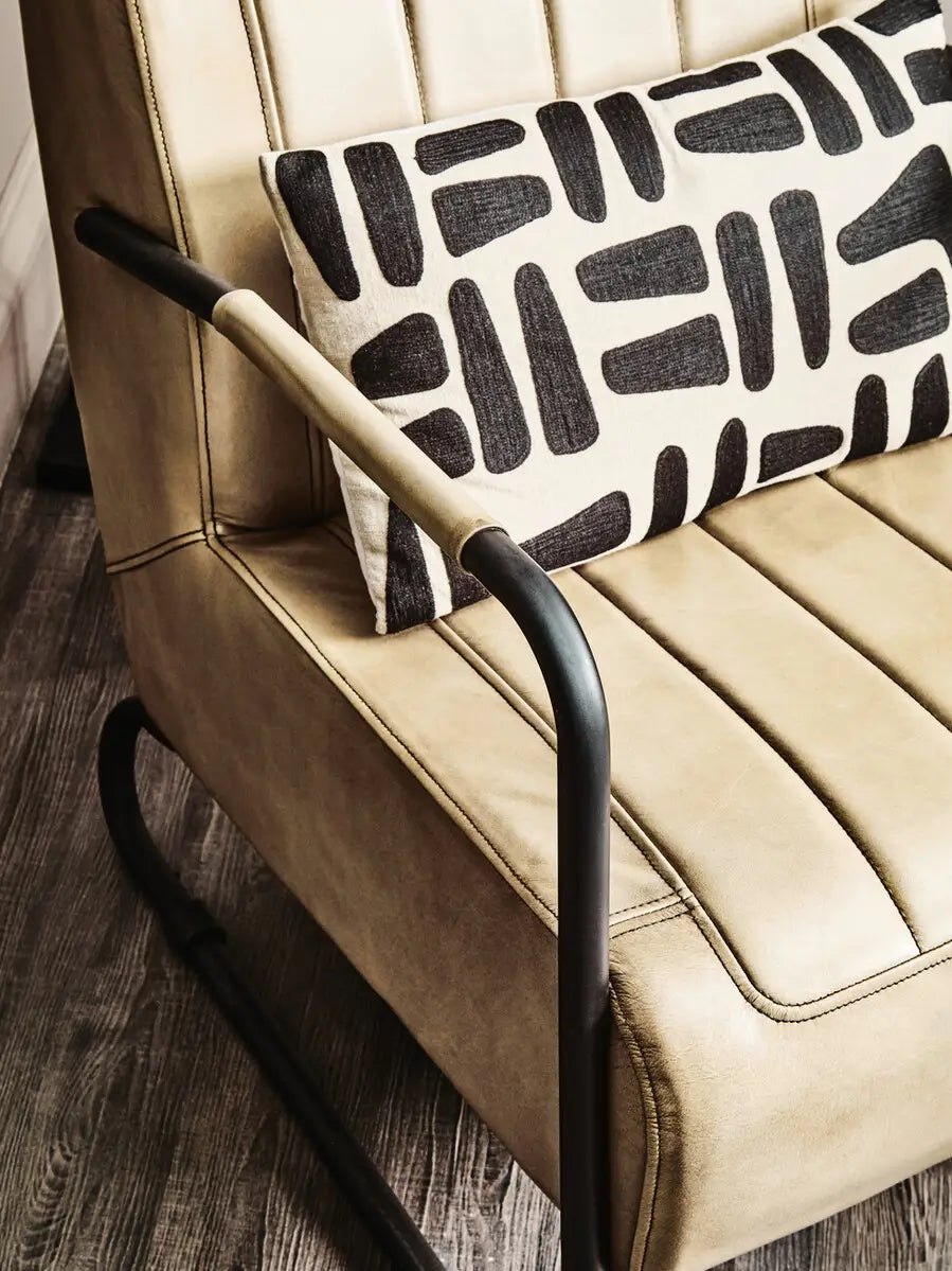  Grey leather armchair with sleek black iron frame.