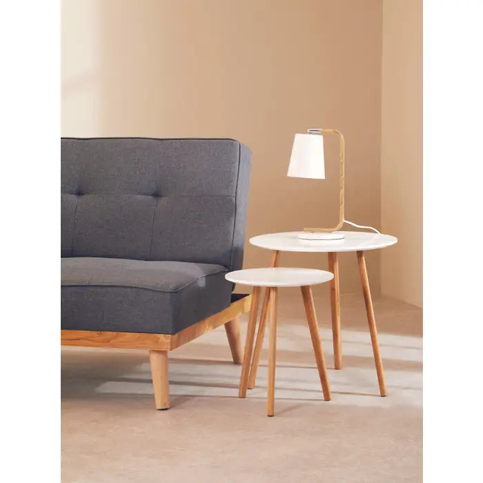 Nest of two round tables with wooden legs and white tops.