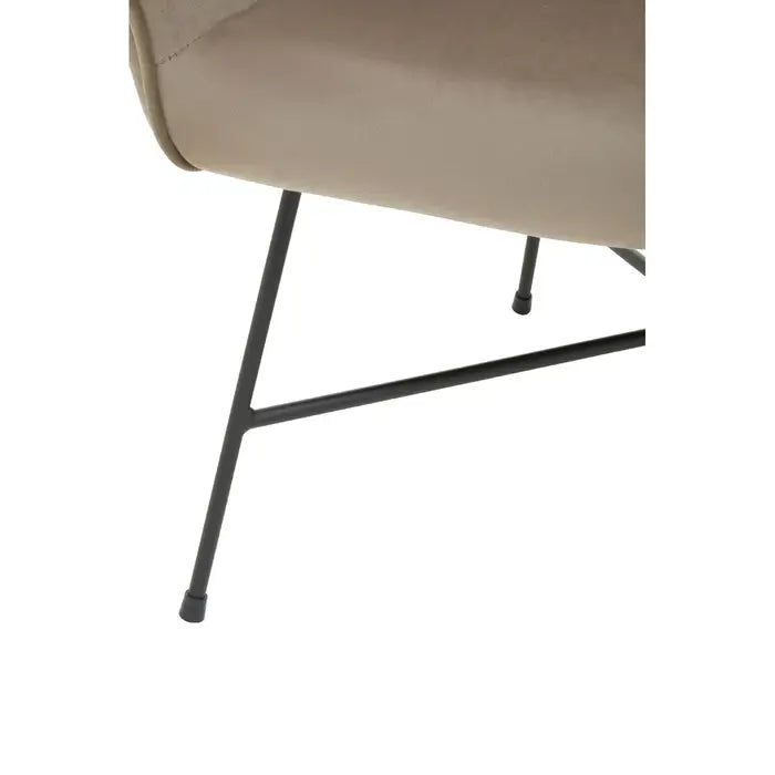 Close up of black frame with partial view of mink velvet chair. 