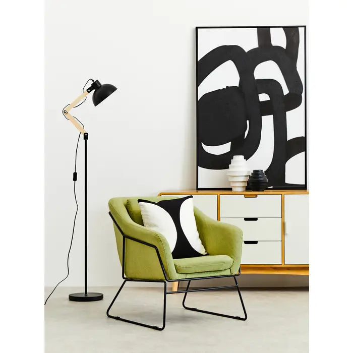 Green comfort chair with black iron frame.