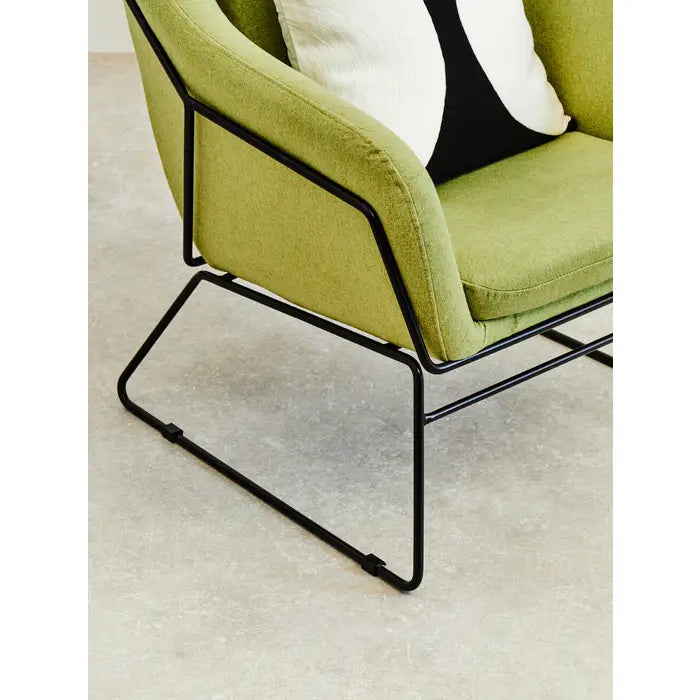 Green comfort chair with black iron frame.
