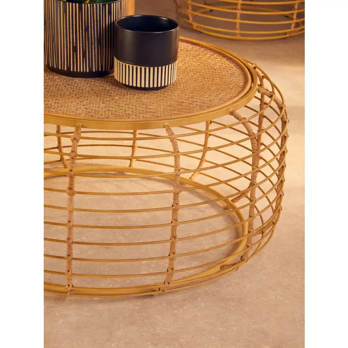 Woven rattan coffee table with a contrasting gold frame.