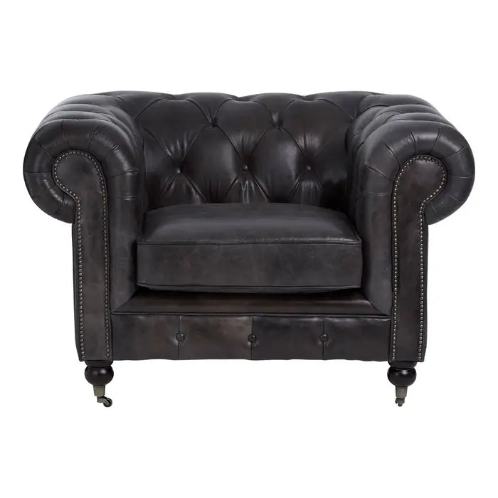 Metallic studs trace the lines of the large rolled armrests, and the traditional Chesterfield style.