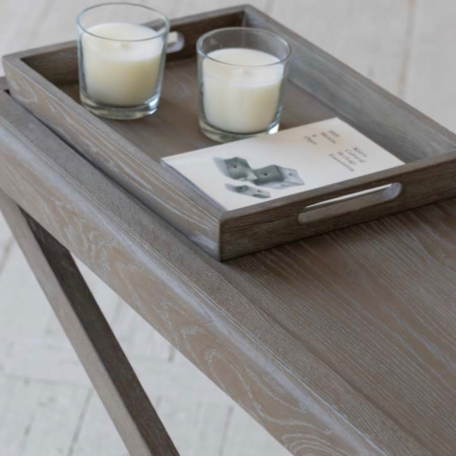 Console table with grey aged oak with visible grain. 