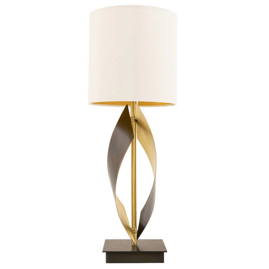 A single lamp with beautiful rich tones of ivory, coupled antique brass stem & base with plain white background. 