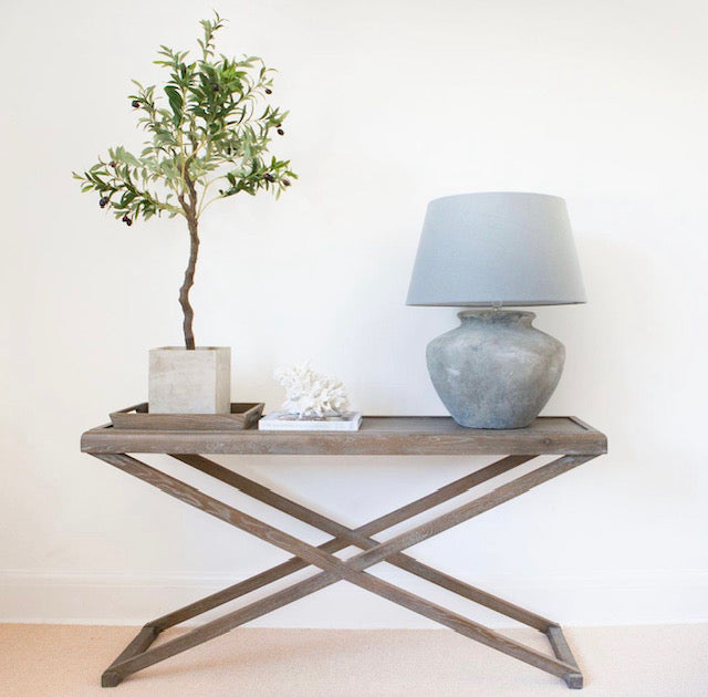 Console table with grey aged oak with visible grain. 